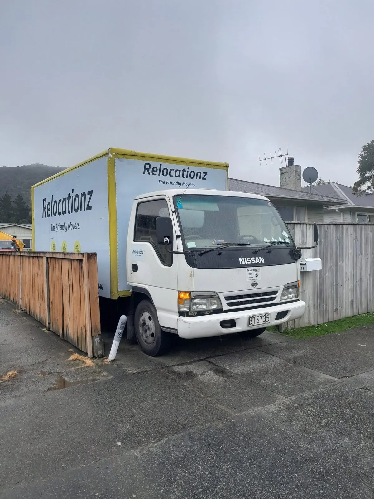 RelocatioNZ truck nosed into a narrow Wellington driveway