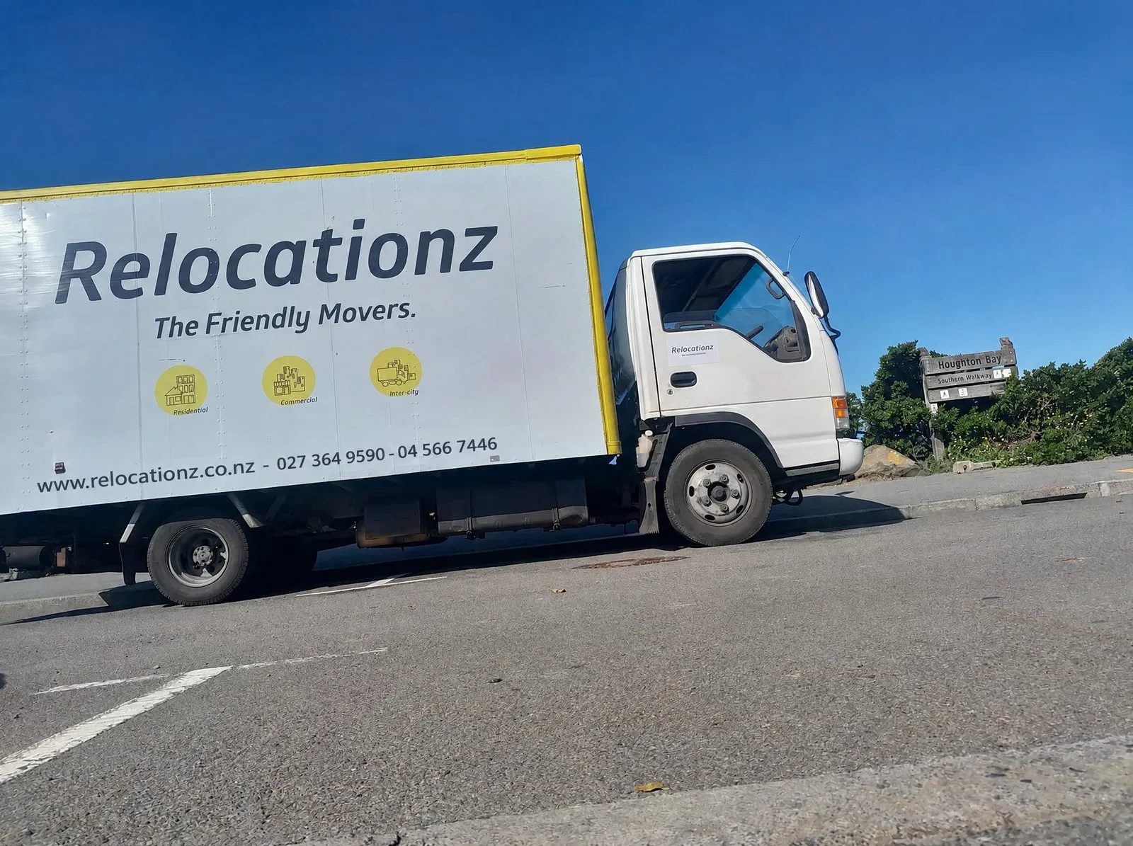 RelocatioNZ truck pulling out onto a suburban Wellington road