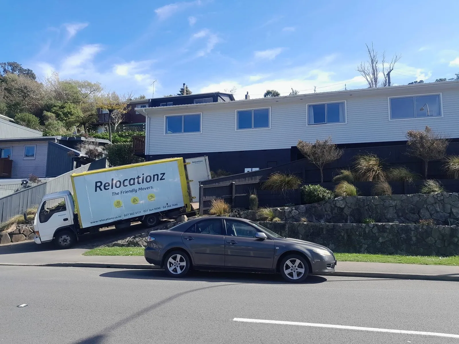 RelocatioNZ truck parked on a hillside Wellington street