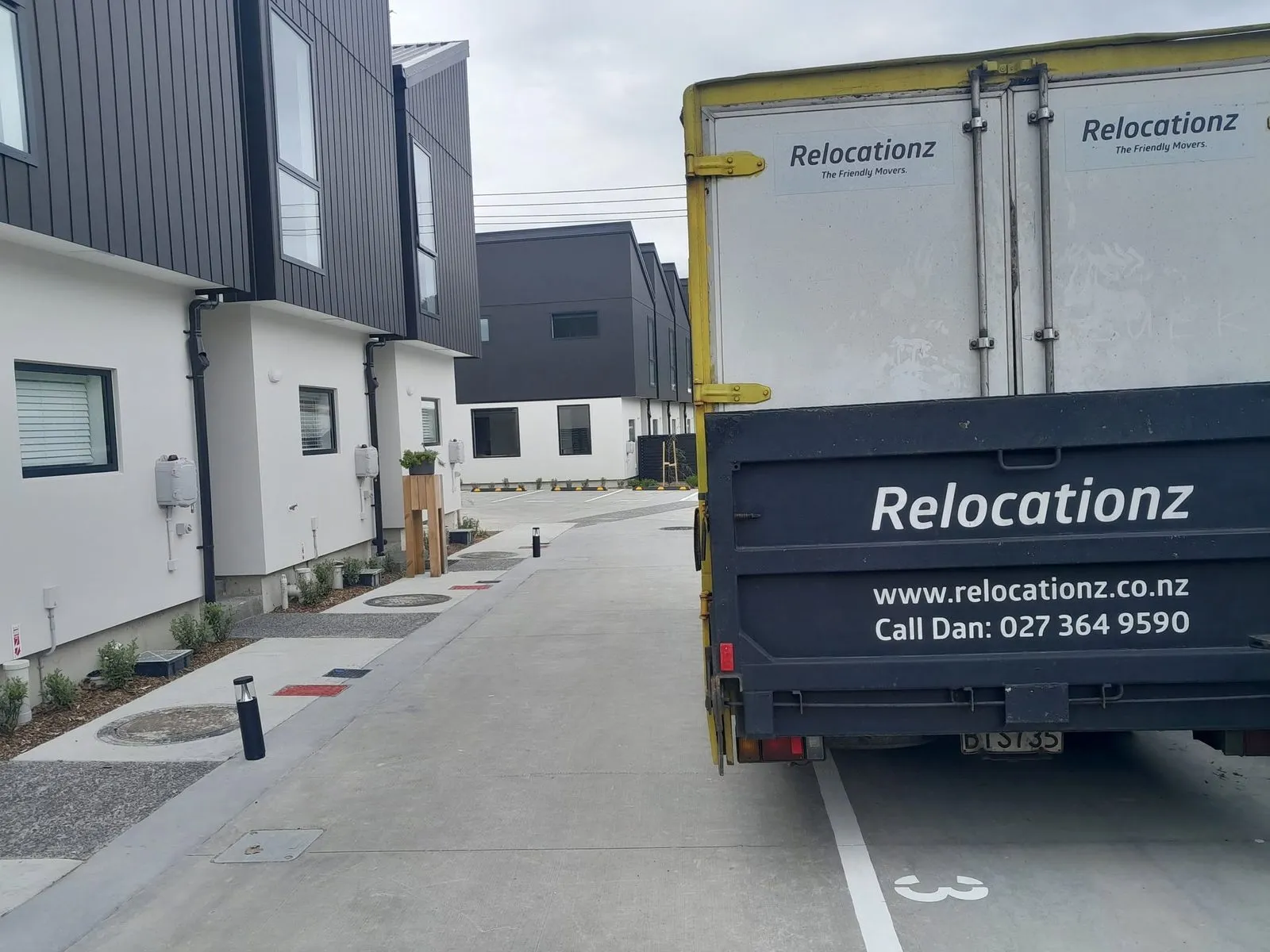 RelocatioNZ truck backed up to a new Wellington townhouse development
